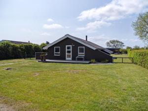 a black house with a large yard at Holiday Home Nilsa - 400m from the sea by Interhome in Otterup