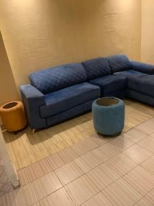 Un sofá azul en una sala de estar. en Living homes enterprise, en Abuja