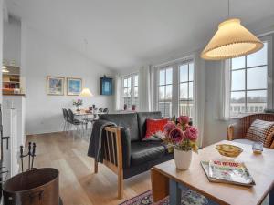 a living room with a couch and a table at Holiday Home Marga - 400m from the sea by Interhome in Aabenraa
