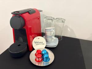 a table with a blender and a plate with chocolates at Grande Cittadella Rooms in Genova