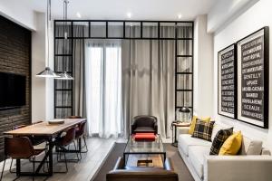 a living room with a couch and a table at Midtown Apartments in Barcelona