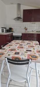 a kitchen with a table with a pattern on it at Mont gîte de tournée in Montournais