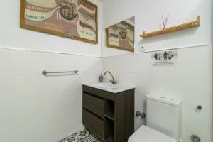 a white bathroom with a toilet and a sink at Barcelona Studios with private kitchen, toilet & shower 20min from the center 5min to the beach in Sant Adria de Besos +37 photos