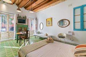 a bedroom with a bed and a table and chairs at Barcelona Studios with private kitchen, toilet & shower 20min from the center 5min to the beach in Sant Adria de Besos
