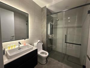 a bathroom with a sink and a toilet and a shower at Axon Residence KLCC At Kuala lumpur in Kuala Lumpur +38 photos