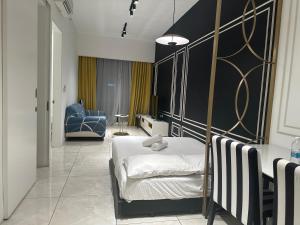 a bedroom with a bed and a blue chair at Axon Residence KLCC At Kuala lumpur in Kuala Lumpur