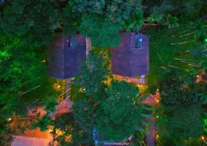 an overhead view of a house with trees and lights at Kedara Resort Wayanad by VOYE HOMES in Sultan Bathery