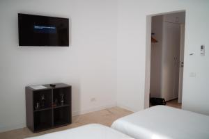 a room with two beds and a flat screen tv at Complex Chitu, Odihna, Camere Cozy si Cazino in Izbiceni