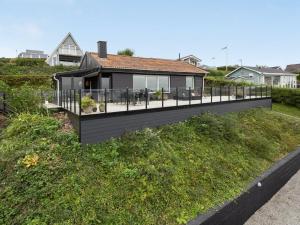 a house on a hill with a black deck at Holiday Home Karli - 330m to the fjord by Interhome in Aabenraa