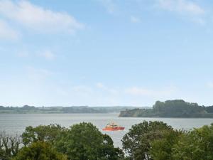 a red boat in the middle of the water at Holiday Home Karli - 330m to the fjord by Interhome in Aabenraa