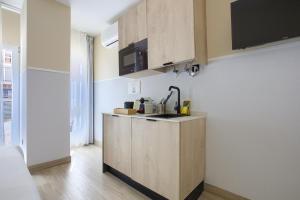 a kitchen with a sink and a counter top at Dobo Madrid CV93 in Madrid