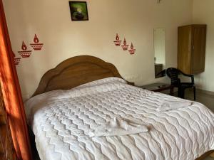 a bedroom with a bed with a wooden head board at Mattuppavu Beach House in Vilinjam