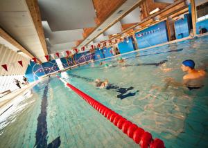 a group of people swimming in a swimming pool at Sport- und Ferienpark Worriken in Butgenbach