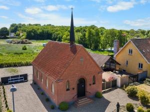 an aerial view of a small brick church with a steeple at Holiday Home Frothi - 550m from the sea by Interhome in Tranekær