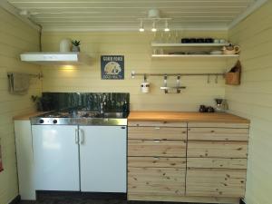 a kitchen with a sink and a counter top at Lillebu in Strand