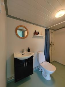 a bathroom with a toilet and a sink at Lillebu in Strand