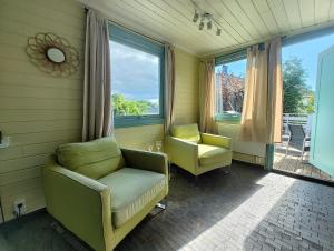 a living room with two chairs and a window at Lillebu in Strand