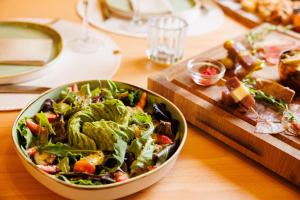 a salad in a bowl on a wooden table at Hotel Inmood San Roque in Sotogrande