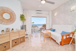a bedroom with a bed and a view of the ocean at Apartamento Gondolas Costa Tropical in Almuñécar