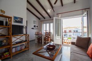 a living room with a couch and a table at Oceanfront paradise - Mahón in Mahón