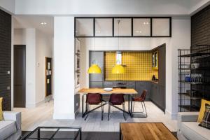 a kitchen and dining room with a table and chairs at Midtown Apartments in Barcelona