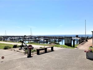 a bench and a fire hydrant in front of a pier at Apartment Irma - 25m from the sea by Interhome in Tranekær
