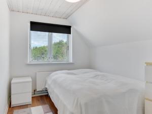 a white bedroom with a bed and a window at Holiday Home Iina - 13km from the sea by Interhome in Bredebro +37 photos