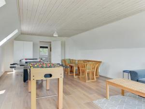 a living room with a table and chairs at Holiday Home Iina - 13km from the sea by Interhome in Bredebro