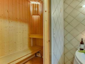 a wooden sauna with a wooden bench in a bathroom at Holiday Home Henrijette - 200m from the sea by Interhome in Sjølund