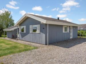 a gray house with a gravel driveway at Holiday Home Denahi - 400m to the fjord by Interhome in Egernsund