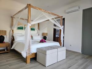 a bedroom with a white bed with a canopy at Villa Solenzara - Private Luxury Residence Nosy Be in Nosy Be +38 photos