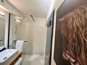 a bathroom with a door with a picture of a woman at Nouveau Refuge de l aiguille in Chamonix-Mont-Blanc +11 photos