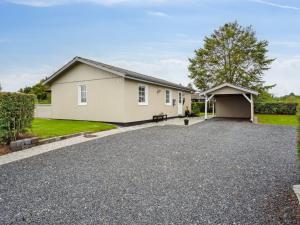 a house with a driveway and a garage at Holiday Home Haralda - 300m from the sea by Interhome in Haderslev