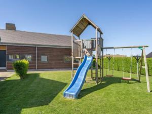 a playground with a slide in a yard at Holiday Home Hans - 700m from the sea by Interhome in Neder Lysabild