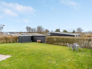 a yard with a table and chairs in it at Holiday Home Aloisia - 300m from the sea by Interhome in Broager