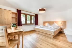 a bedroom with two beds and a table at Jagdhaus Walch in Klösterle +36 photos