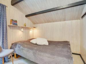 a bedroom with a bed and a wooden ceiling at Holiday Home Rentje - 31km from the sea by Interhome in Toftlund