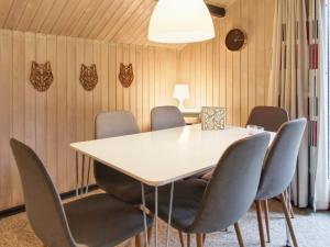 a meeting room with a white table and chairs at Holiday Home Rentje - 31km from the sea by Interhome in Toftlund +17 photos