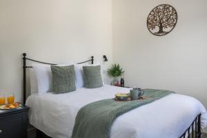 a bedroom with a bed with a tray of food on it at Lakeside Lodge in Eastleigh
