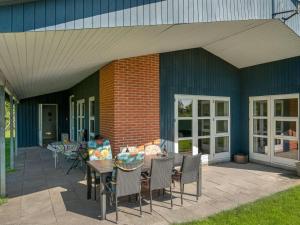 a patio with a table and chairs and a building at Holiday Home Farnke - 600m from the sea by Interhome in Egernsund +27 photos