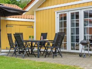 a patio table and chairs in front of a house at Apartment Karina - 150m to the fjord by Interhome in Gråsten