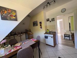 a kitchen and dining room with a table and a sink at Haus Lönsweg in Bad Bevensen
