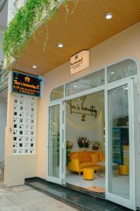 a store front of a store with a yellow couch inside at Tom's Homestay 2 in Hue +38 photos