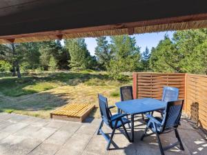 a blue table and chairs on a patio at Holiday Home Alflak - 5-2km from the sea by Interhome in Vesterhede +17 photos