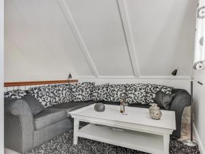 a living room with a couch and a table at Apartment Joar - 5m to the inlet by Interhome in Gråsten