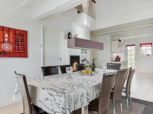a dining room with a white table and chairs at Apartment Joar - 5m to the inlet by Interhome in Gråsten +34 photos
