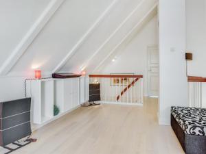 a white attic room with a bed and a staircase at Apartment Joar - 5m to the inlet by Interhome in Gråsten