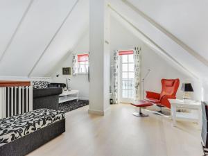 a bedroom with a bed and a chair and a desk at Apartment Joar - 5m to the inlet by Interhome in Gråsten