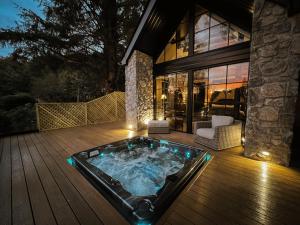 a hot tub on the deck of a house at Glencruitten House in Oban