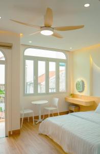 a bedroom with a bed and a table and chairs at Tom's Homestay 2 in Hue